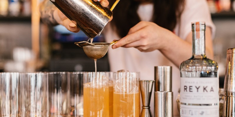 Image Of A Bartender Pouring A Cocktail