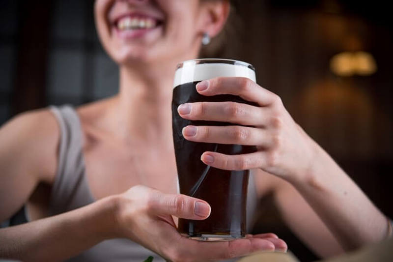 Person Enjoying Guinness Stout.jpg